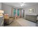 Bedroom featuring a glider, dresser, changing table, and a bright window at 646 Marsh Reed Dr, Winter Garden, FL 34787