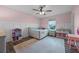 Lovely bedroom with white paneling, stylish ceiling fan, and a large window at 646 Marsh Reed Dr, Winter Garden, FL 34787