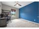 Bedroom features a tranquil blue accent wall, neutral carpet, ceiling fan and a window with a serene outdoor view at 646 Marsh Reed Dr, Winter Garden, FL 34787