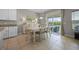 Cozy dining room featuring a white table set, sliding glass doors to the patio and plenty of natural light at 646 Marsh Reed Dr, Winter Garden, FL 34787