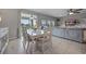 Bright dining area featuring a white table set, buffet cabinet, sliding doors to the patio, and open-concept design at 646 Marsh Reed Dr, Winter Garden, FL 34787