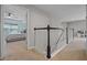 Hallway view showcasing a dark banister, with a glimpse into a bedroom with light streaming in at 646 Marsh Reed Dr, Winter Garden, FL 34787