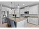 Bright kitchen featuring a large island, granite countertops, stainless steel appliances, and ample storage at 646 Marsh Reed Dr, Winter Garden, FL 34787