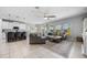 Open concept living room features neutral tones, tile floors and ample natural light from large windows overlooking the backyard at 646 Marsh Reed Dr, Winter Garden, FL 34787