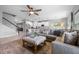 Comfortable open concept living room features a plush sectional sofa, ceiling fan, and seamless flow to the kitchen at 646 Marsh Reed Dr, Winter Garden, FL 34787