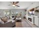 Cozy living room featuring a comfortable sectional sofa, fireplace, and lots of natural light at 646 Marsh Reed Dr, Winter Garden, FL 34787