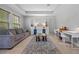 Bright living room featuring a tray ceiling, comfortable sofa, and a activity area at 646 Marsh Reed Dr, Winter Garden, FL 34787