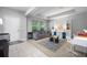 Inviting living room with neutral tones, built-in shelving, and large windows at 646 Marsh Reed Dr, Winter Garden, FL 34787