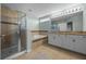 Elegant bathroom featuring double sinks, a glass shower, and a separate soaking tub at 646 Marsh Reed Dr, Winter Garden, FL 34787