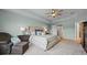 Light and airy main bedroom with a plush bed, tray ceiling, and ample closet space at 646 Marsh Reed Dr, Winter Garden, FL 34787