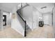 Inviting staircase with tile floors, black and white banister, and access to the upper level at 646 Marsh Reed Dr, Winter Garden, FL 34787