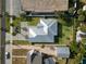 Aerial view of the home showing the roof, brick driveway, and surrounding landscaping at 725 N Grandview Ave, Daytona Beach, FL 32118