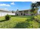 The backyard features green grass and privacy fencing at 725 N Grandview Ave, Daytona Beach, FL 32118