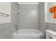 Bathroom tub and shower with gray tile surround and chrome fixtures at 725 N Grandview Ave, Daytona Beach, FL 32118
