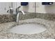 Close up of a bathroom granite countertop with a white sink and chrome faucet at 725 N Grandview Ave, Daytona Beach, FL 32118