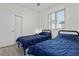 Bedroom featuring two twin beds, and a window with white blinds at 725 N Grandview Ave, Daytona Beach, FL 32118
