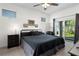 Bedroom with a ceiling fan, a sliding glass door, and three framed pictures on the wall at 725 N Grandview Ave, Daytona Beach, FL 32118