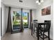 The dining area features a dark dining table and chairs with a view of the fenced backyard at 725 N Grandview Ave, Daytona Beach, FL 32118