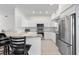 Bright kitchen features stainless steel appliances, white cabinets, granite countertops, and modern hardware at 725 N Grandview Ave, Daytona Beach, FL 32118