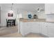 Open kitchen with granite countertop bar and adjacent dining area at 725 N Grandview Ave, Daytona Beach, FL 32118