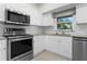 The kitchen offers stainless appliances, white cabinets, and granite countertops with plenty of cabinet space at 725 N Grandview Ave, Daytona Beach, FL 32118