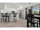 Modern kitchen and dining area with stainless steel appliances, white cabinets, and breakfast bar seating at 725 N Grandview Ave, Daytona Beach, FL 32118