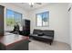 Office features an office chair and futon style sofa for a comfortable work area at 725 N Grandview Ave, Daytona Beach, FL 32118