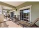 A covered balcony features seating and views of the surrounding nature at 7660 Whisper Way # 402, Reunion, FL 34747