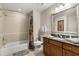 The bathroom features a shower-tub combination and a vanity with granite countertop at 7660 Whisper Way # 402, Reunion, FL 34747