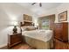 Serene bedroom with hardwood floors, a ceiling fan, and tastefully coordinated furnishings at 7660 Whisper Way # 402, Reunion, FL 34747