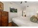 Tranquil bedroom featuring a TV, dresser, and cozy bed, providing a comfortable and stylish retreat at 7660 Whisper Way # 402, Reunion, FL 34747