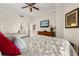 Bright bedroom features two beds, a ceiling fan, and a dresser with a television at 7660 Whisper Way # 402, Reunion, FL 34747
