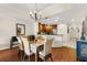 Elegant dining area with hardwood floors, chandelier, and open access to the modern kitchen, perfect for gatherings at 7660 Whisper Way # 402, Reunion, FL 34747