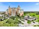 Beautiful exterior view of a resort complex with a golf course, tall towers, and lush landscaping at 7660 Whisper Way # 402, Reunion, FL 34747