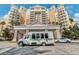 Elegant building with a welcoming entrance, showcasing architecture and convenient shuttle service at 7660 Whisper Way # 402, Reunion, FL 34747