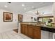 Bright, stylish kitchen area with stainless steel dishwasher seamlessly integrated into the cabinetry at 7660 Whisper Way # 402, Reunion, FL 34747