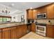 Well-equipped kitchen with stainless steel appliances, granite countertops, and tile flooring for style and functionality at 7660 Whisper Way # 402, Reunion, FL 34747