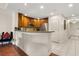 Open kitchen design with stainless appliances, a convenient breakfast bar, and tile flooring for modern living and entertaining at 7660 Whisper Way # 402, Reunion, FL 34747