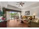 Cozy living room with a balcony offering scenic views, perfect for relaxing and entertaining at 7660 Whisper Way # 402, Reunion, FL 34747