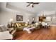 Inviting living space with hardwood floors, comfortable seating, and a view into the dining area, ideal for relaxation and entertaining at 7660 Whisper Way # 402, Reunion, FL 34747