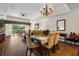 Spacious living and dining area with hardwood floors, a ceiling fan, and abundant natural light for relaxed, stylish living at 7660 Whisper Way # 402, Reunion, FL 34747