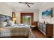 Relaxing bedroom features balcony access, TV, and decorative furniture for ultimate comfort at 7660 Whisper Way # 402, Reunion, FL 34747