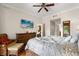 Spacious bedroom with balcony view, TV, and well-appointed furniture for a restful retreat at 7660 Whisper Way # 402, Reunion, FL 34747