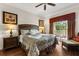 Comfortable bedroom with balcony access, decorated with lamps, art, and a seating area at 7660 Whisper Way # 402, Reunion, FL 34747