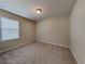 Neutral bedroom with large window and carpet flooring for a comfortable and bright living space at 7806 Tanbier Dr, Orlando, FL 32818