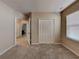 Carpeted bedroom with closet and view to bathroom at 7806 Tanbier Dr, Orlando, FL 32818