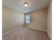 Cozy bedroom with carpet flooring, neutral walls, and a window at 7806 Tanbier Dr, Orlando, FL 32818