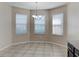 Breakfast nook with a tile floor, three windows, and a hanging light at 7806 Tanbier Dr, Orlando, FL 32818