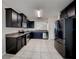 Modern kitchen with stainless steel appliances, dark cabinets, and granite countertops at 7806 Tanbier Dr, Orlando, FL 32818