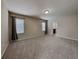 Bright main bedroom with carpet, two windows, and neutral paint at 7806 Tanbier Dr, Orlando, FL 32818